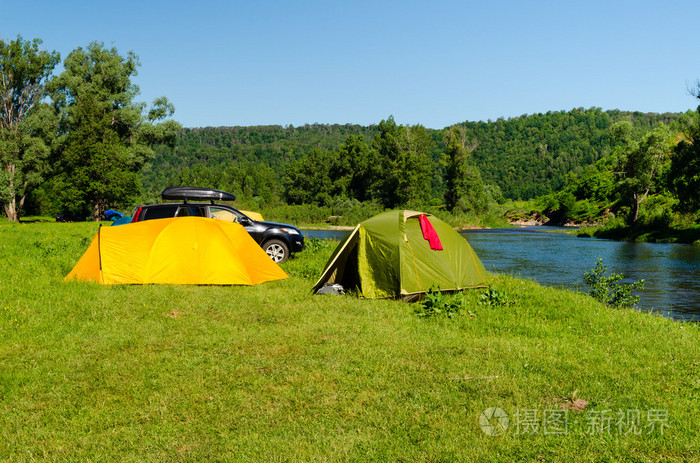 旅游营地帐篷和汽车在河岸边