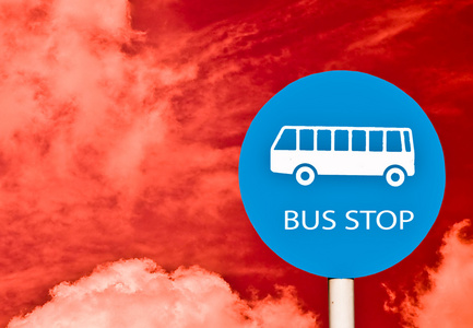 停止上邮政杆红色的天空背景上孤立的标志 ofbus