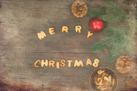 快乐圣诞词用饼干的字母写在木桌子上