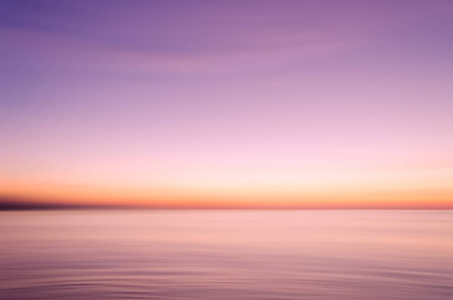 运动模糊热带日落海滩与 bokeh 太阳光波抽象背景