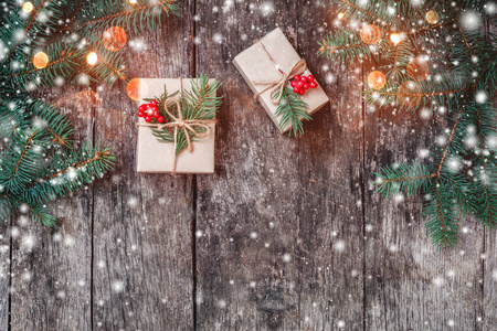 圣诞节背景与木制背景与冷杉的枝条上的圣诞礼物。圣诞节和新年快乐组成。平躺，顶视图