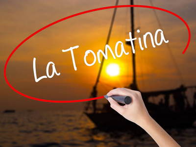 女人的手写作 La Tomatina 用记号笔在透明博