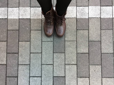 混凝土砌块背景上的棕色靴子鞋的顶部视图