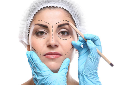 女性的脸，白色背景上绘制标记的外科医生。整形外科概念