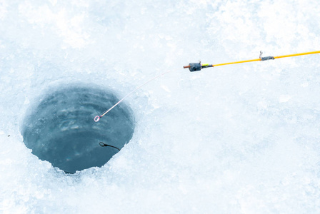 冰洞和冬季钓鱼杆