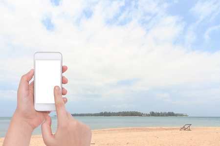 女手一直举着手机模糊旧沙滩木椅在 Ko 麦，泰国的热带海滩上