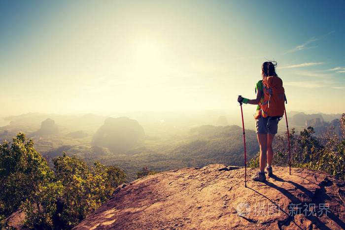 女背包客站在山顶上