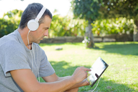 人与戴着耳机的 tablet pc 听音乐放松