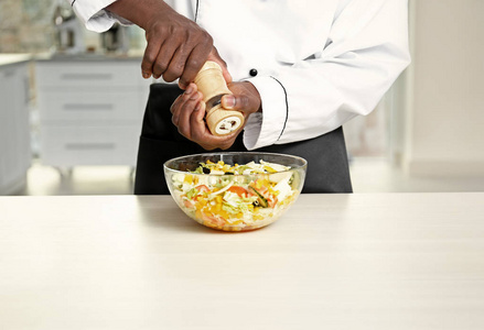 非洲裔美国厨师烹饪美味沙拉在厨房照片