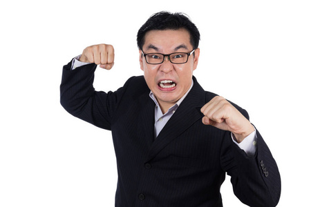 愤怒亚洲中国男人穿西装,控股两拳照片
