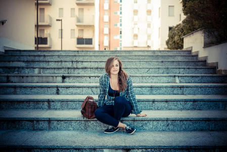 年轻漂亮的金发时髦女子在听音乐