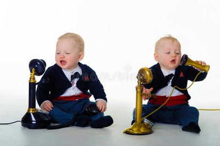 双胞胎男婴用老式电话交流