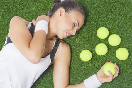 梦寐以求的女子网球运动员躺在人工草地上的画像