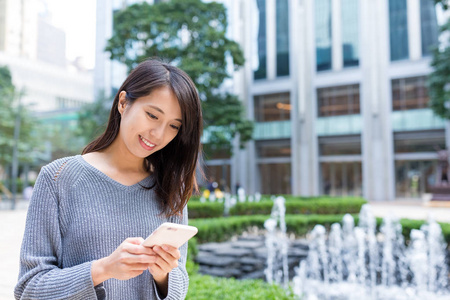 在移动电话上发送短信的女人