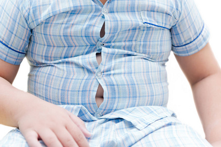 超重的肥胖胖男孩.睡衣的紧身衬衣照片