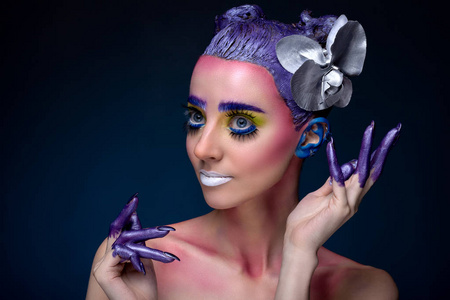 蓝色背景上的创意彩妆与女子肖像照片