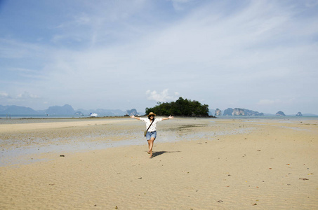 泰国女子行走和肖像为拍张照片，在海滩上的方式
