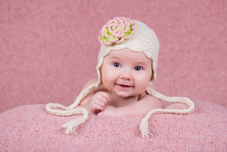 新生女婴在温暖的针织帽，有一朵花