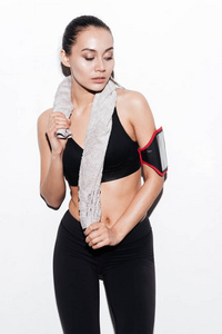 袖标和毛巾的美丽年轻健身女人的画像