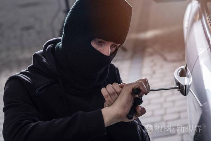 在黑色头套试图闯入汽车汽车小偷