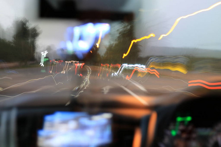 道路夜景从里面车天然光街道和其他汽车是运动模糊，模糊图像从里面一辆车行驶在夜间