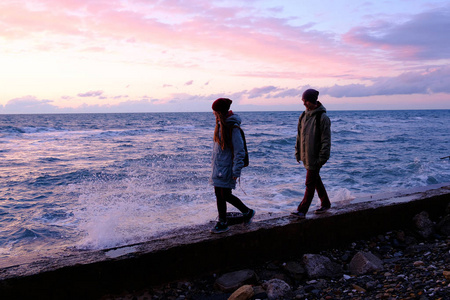 年轻夫妻沿着岸边散步