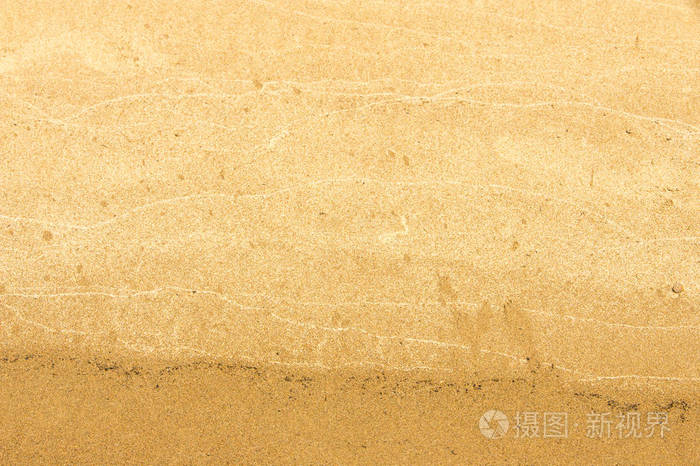 纹理背景。 海滩上的沙子。 松散的粒状物质，淡黄棕色，由硅质和其他岩石侵蚀而成，构成海滩的主要组成部分