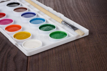 桌子上有油漆和刷子的调色板