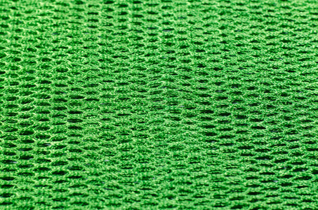 抽象的绿色背景，从合成纤维织物在黑色的阴影