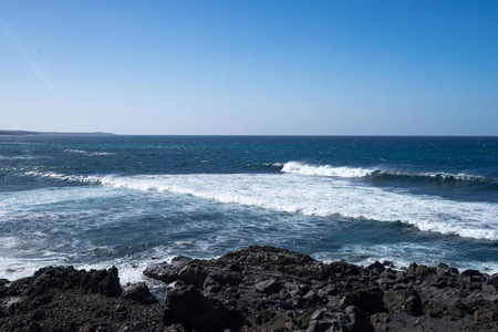 海浪对黑色岩石的海岸线