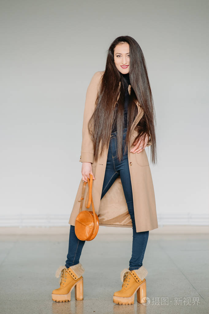 时尚概念全身肖像的巨大的灰色墙附近的年轻女孩健美过滤后的照片