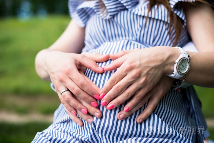 怀孕的夫妇丈夫抚摸他妻子的肚子