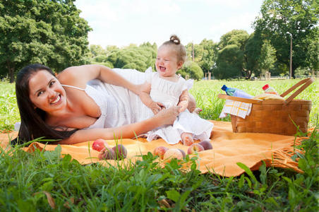 年轻快乐的母亲带着女儿在公园里
