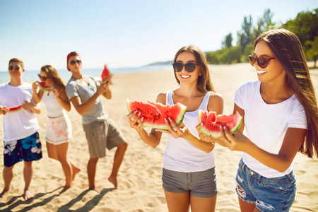 群的朋友开心吃西瓜。上海滩。优秀的晴朗天气。.超级的心情。夏天的概念