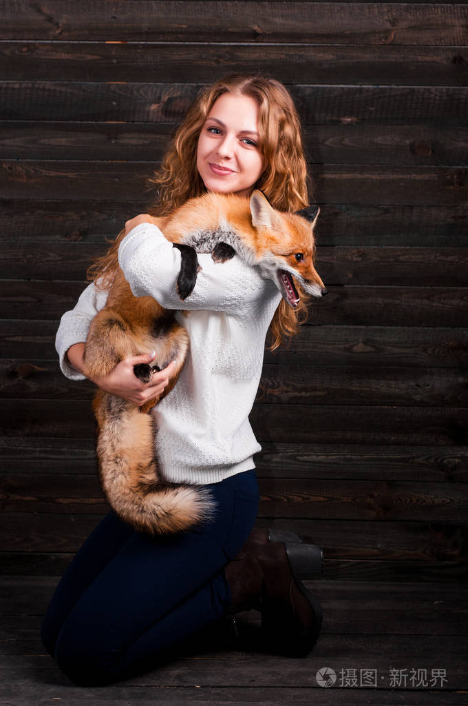 年轻漂亮的女孩抱着一种野生狐狸动物是一个人的精神创伤救起她现在像