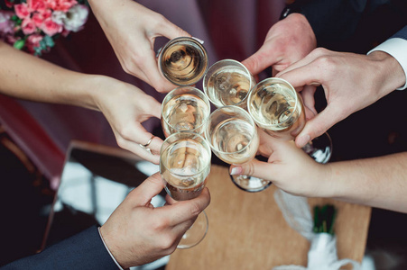 人们抱在手里的眼镜，白葡萄酒。婚宴