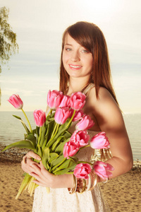 手捧鲜花，在海滩上的女人的画像