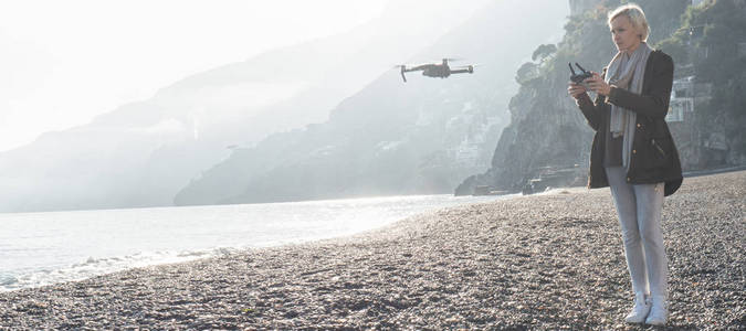 无人驾驶飞机飞越意大利海岸的年轻女孩