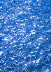 纹理背景。纹理背景。池中的水照反光..从阳光照射到海浪上