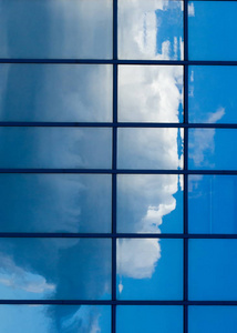 纹理，图案，背景..建筑窗户的反射。蓝色的窗户，云层反射在窗户上
