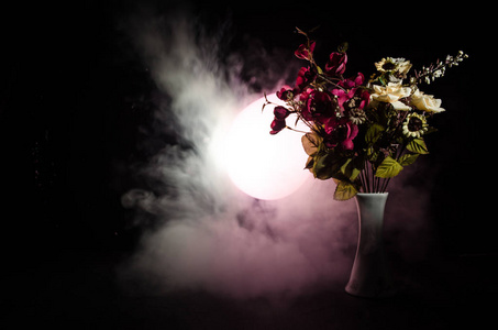 如诗如画的紫色春花在玻璃花瓶站成一排在一个黑暗的背景，用光镜和雾的星星。关闭