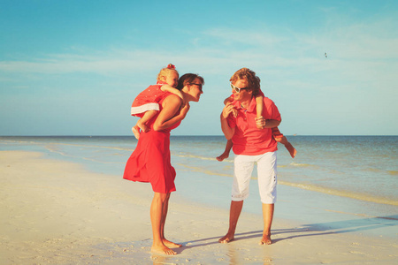 幸福的家庭，有两个孩子在海滩散步