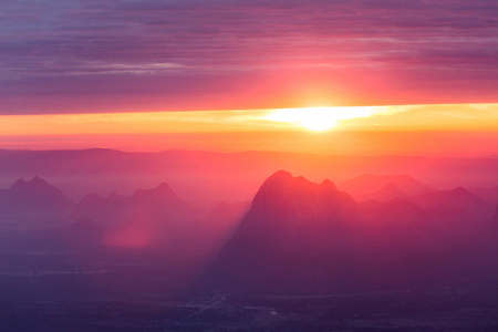 柔和的焦点和模糊的美丽的风景在山顶与太阳在黎明