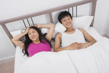 满意的年轻夫妇在床上