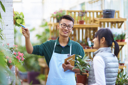 他在店里的顾客交谈的男性花店