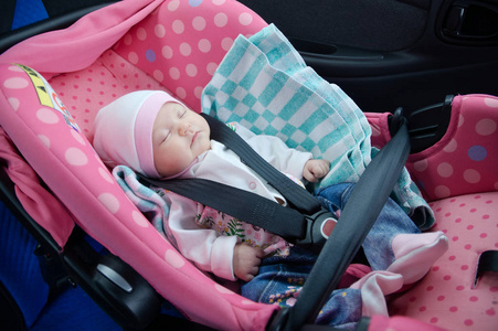 新生儿睡在汽车座椅。安全概念。婴儿的女婴。安全驾驶与儿童。婴儿保健的生活方式。可爱的宝宝睡在车里