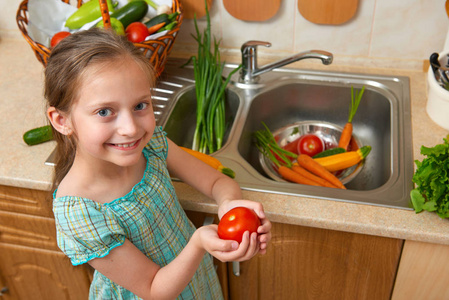 儿童女孩洗蔬菜和新鲜水果，在厨房内，健康食品的概念