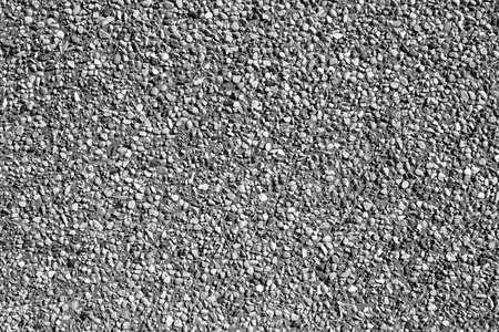 小小的砂石头的沙墙的背景纹理或砂墙.n照片