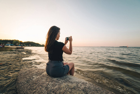 女性坐在海滩上与它的海边图片图片