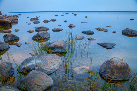 用石头在水中，长时间曝光日落之后波罗的海海边
